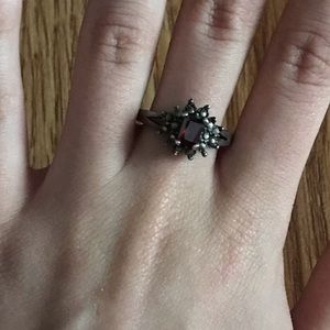 Black and silver ring with burgundy stone